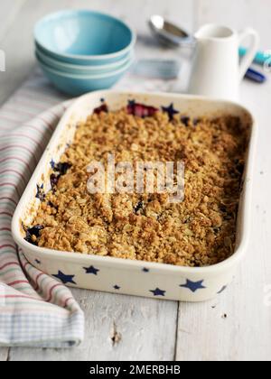 Apple and grape crumble bake in pie dish Stock Photo