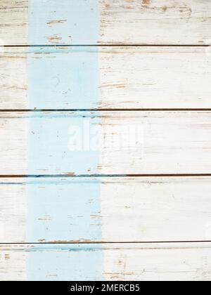 Wooden boards with blue strip painted across Stock Photo