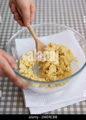 Making basic cookie or biscuit dough, mixing in flour with spoon Stock Photo