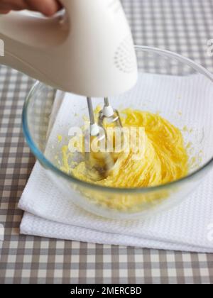 Woman using electric mixer to mix ingredients for dough of sugar, beaten  eggs, butter and flour while making cookies in the kitchen at home closeup  Stock Photo - Alamy