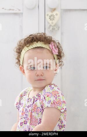 Baby girl wearing knitted headband, 14 months Stock Photo