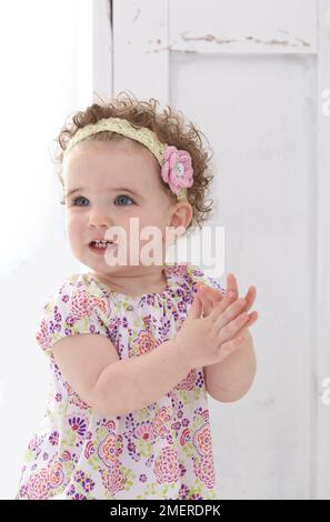 Baby girl wearing knitted headband, 14 months Stock Photo
