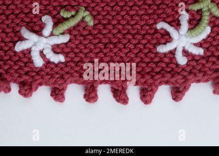 Knitted baby's skirt with daisy detail Stock Photo