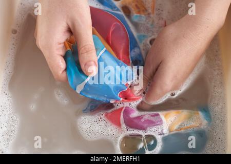 Washing painted silk scarf Stock Photo