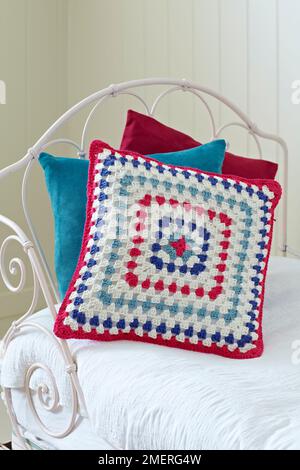 Crocheted granny square cushion Stock Photo