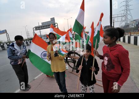 January 24, 2023, Delhi NCR, Ghaziabad, Uttar Pradesh, India: National Flag sale on Road on the forthcoming Republic day, buying by Girls in International Girl Day on the eve of Indian Republic day. (Credit Image: © Ravi Batra/ZUMA Press Wire) EDITORIAL USAGE ONLY! Not for Commercial USAGE! Stock Photo