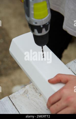 Drilling small holes to bottom of guttering Stock Photo