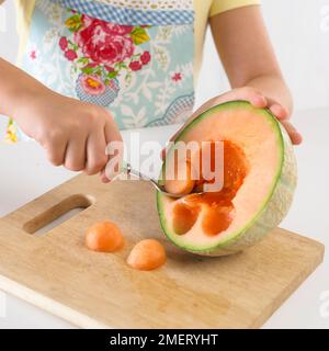 Girl balling a melon Stock Photo