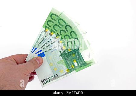 100 euro banknotes, held as fans in one hand Stock Photo