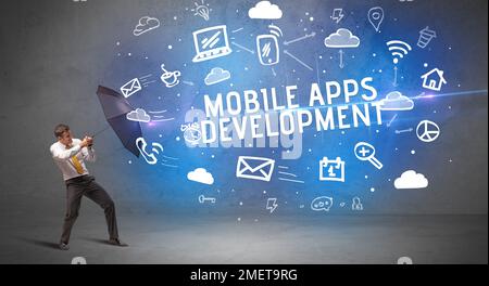 Businessman defending with umbrella, modern technology concept Stock Photo