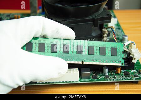 side view mechanic holding ram of the computer motherboard Stock Photo