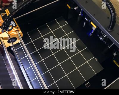 printer 3d device with numerically controlled machine,along the rails of the head extruder,prints creates models details of a figure made of polymer p Stock Photo