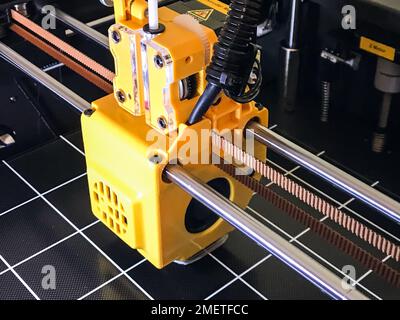 printer 3d device with numerically controlled machine,along the rails of the head extruder,prints creates models details of a figure made of polymer p Stock Photo