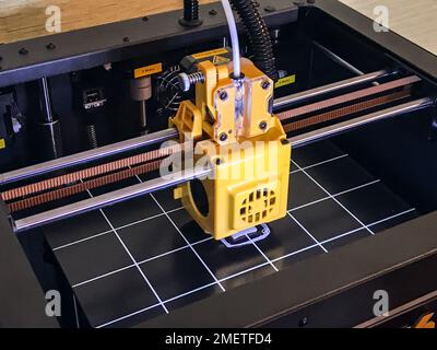 printer 3d device with numerically controlled machine,along the rails of the head extruder,prints creates models details of a figure made of polymer p Stock Photo