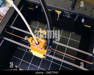printer 3d device with numerically controlled machine,along the rails of the head extruder,prints creates models details of a figure made of polymer p Stock Photo