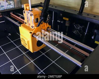 printer 3d device with numerically controlled machine,along the rails of the head extruder,prints creates models details of a figure made of polymer p Stock Photo
