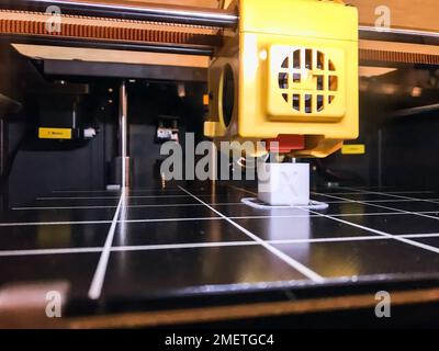 printer 3d device with numerically controlled machine,along the rails of the head extruder,prints creates models details of a figure made of polymer p Stock Photo