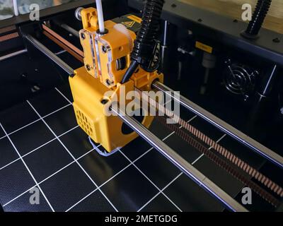 printer 3d device with numerically controlled machine,along the rails of the head extruder,prints creates models details of a figure made of polymer p Stock Photo