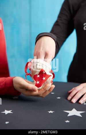 Coin trick using small bag and chilled coins Stock Photo