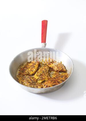 Blackened mahi-mahi fillets (white fish), with thyme and oregano, in pan Stock Photo