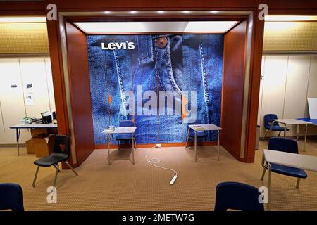 A large Levi's jeans display highlights the center of an empty classroom,  built in a former department store, at Downtown Burlington High School,  Monday, March 22, 2021, in Burlington, Vt. Students who