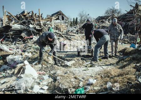 Cleaning up the ruins of the Bohunia residential neighbourhood, it was destroyed by a Russian missile attack on the night of 1 to 2 March 2022, the Stock Photo