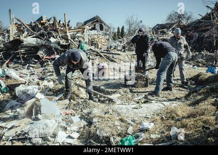 Cleaning up the ruins of the Bohunia residential neighbourhood, it was destroyed by a Russian missile attack on the night of 1 to 2 March 2022, the Stock Photo