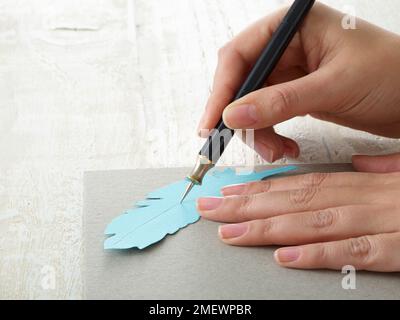 Papercraft Paper feather gift wrap Stock Photo