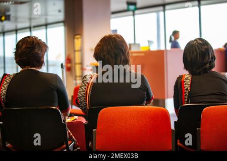 Saree clad air hostess aged sitting at airport Stock Photo