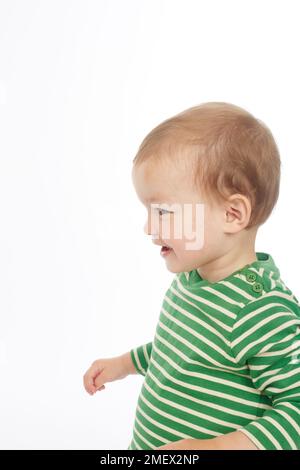 Little boy in green stripey top smiling (Model age - 22 months) Stock Photo