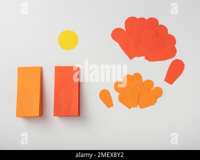 Yellow paper circle, orange paper petals, petal shape drawn on folded orange paper Stock Photo