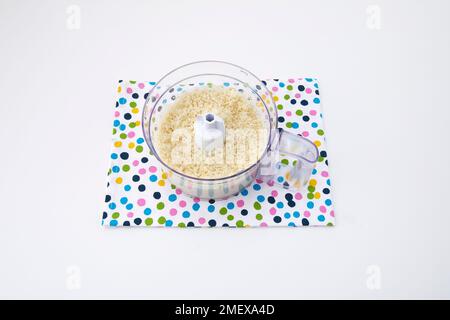 Cauliflower rice blitzed in food processor on spotty teatowel Stock Photo