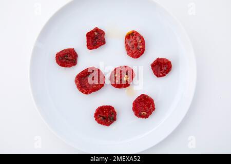 Sundried cherry tomatoes overhead on white background Stock Photo