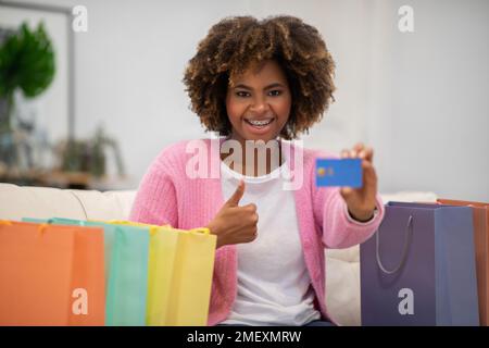 Overjoyed young black woman customer shopping from home Stock Photo