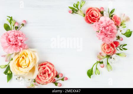 Beautiful spring flowers on white wooden background. Festive floral concept with clean space for text. Top view. Stock Photo