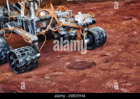 Close-up shot of Mars rover exploration vehicle on red planet surface Stock Photo