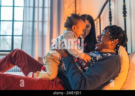 Smiling African father holding his biracial son . High quality photo Stock Photo