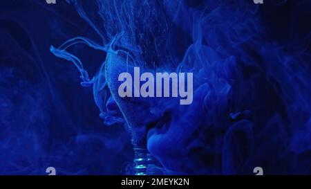 Broken lamp smog cloud blue light bulb on dark Stock Photo