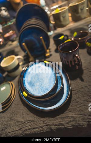 Handcrafted original cups and plates at handcraft market. High quality photo Stock Photo