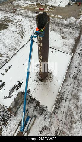 Detroit, Michigan, USA. 23rd Jan, 2023. Workers tear down the chimney of the power plant at Continental Motors. It is the last of several buildings to be demolished. The plant made auto and aircraft engines from 1912 until 1955, employing as many as 8,000 workers. Credit: Jim West/Alamy Live News Stock Photo