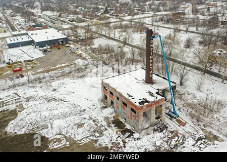 Detroit, Michigan, USA. 23rd Jan, 2023. Workers tear down the chimney of the power plant at Continental Motors. It is the last of several buildings to be demolished. The plant made auto and aircraft engines from 1912 until 1955, employing as many as 8,000 workers. Credit: Jim West/Alamy Live News Stock Photo