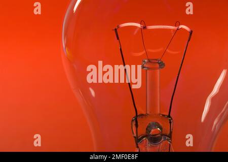 A lamp bulb and a  fluorescent tungsten spiral showing the presence of electric energy Stock Photo