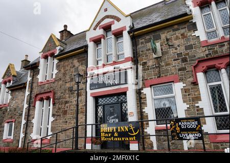 Buncrana, Ireland- Jan 14, 2023:  The front of The Drift Inn pub in the Village of Buncrana in County Donegal, Ireland Stock Photo