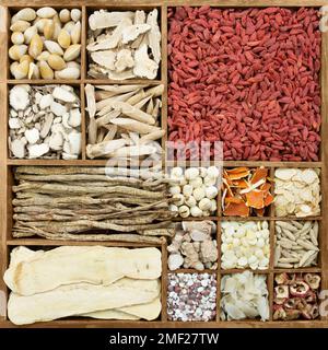 Chinese herb medicines in a rustic wooden box Stock Photo