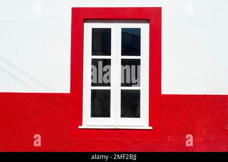 red and white painted wall with a window Stock Photo