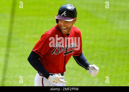 FILE - Atlanta Braves' Freddie Freeman smiles after scoring on a hit by  Marcell Ozuna against the Los Angeles Dodgers during the sixth inning in  Game 4 of a baseball National League