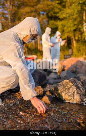 Team of scientists collecting water samples at seashore Stock Photo