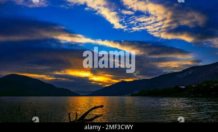 sunrise in winter over Lake Klimkowskie, streaks of clouds in the sky Stock Photo