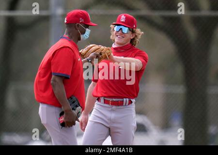 St. Louis Cardinals Hall-of-Famer Ozzie Smith gestures to his longtime  friend and teammate, assistant coach Willie McGee, on the Cardinals bench  before a baseball game between the Cardinals and the Kansas City