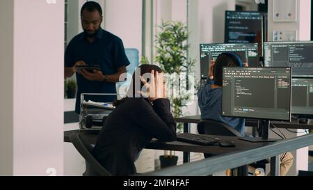 Asian system engineer trying to find html script and code to program cloud computing app, using terminal window. Working with artificial intelligence big data programming language software. Stock Photo